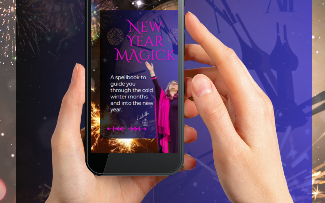 hand holding phone with New Year Magick book